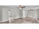 Living room with wood-look floors, ceiling fans, and easy access to other areas at 980 S Mill Ave, Bartow, FL 33830