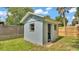 A small, blue cement shed with two windows and a door sits on a grassy lot at 980 S Mill Ave, Bartow, FL 33830