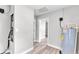 Bright utility room with grey wood-look floors, white walls, and new-looking water heater at 980 S Mill Ave, Bartow, FL 33830