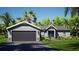 Charming single-story home with a two-car garage, landscaped yard, and a welcoming front porch at 9808 Se 159Th St, Summerfield, FL 34491