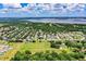 Aerial view of the community's homes amidst a serene lake and verdant landscape on a sunny day at 10 Webb Rd, Winter Haven, FL 33881