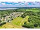 Expansive aerial view of the community surrounded by lush green spaces and a picturesque lake at 10 Webb Rd, Winter Haven, FL 33881