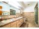 Bathroom with dual sinks, tile, and a glass enclosed shower at 10 Webb Rd, Winter Haven, FL 33881