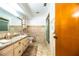 Bathroom featuring a vanity with double sinks, and a walk-in shower at 10 Webb Rd, Winter Haven, FL 33881