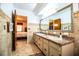 Bathroom featuring a spacious vanity with double sinks, walk-in shower and access to the bedroom at 10 Webb Rd, Winter Haven, FL 33881