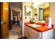 Retro bathroom featuring a bright red countertop and patterned wallpaper, vintage decor, and a classic design at 10 Webb Rd, Winter Haven, FL 33881