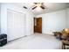 Cozy bedroom with plush carpeting, a ceiling fan, and ample closet space for storage at 10 Webb Rd, Winter Haven, FL 33881