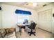 View of the bedroom featuring a cozy seating area, a window with blinds and a spacious closet with louvered doors at 10 Webb Rd, Winter Haven, FL 33881