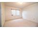 This bedroom features neutral carpeting, and bright natural light creating a serene atmosphere at 10 Webb Rd, Winter Haven, FL 33881