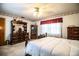 Inviting bedroom with a wooden bed frame, dresser, and a well-lit window at 10 Webb Rd, Winter Haven, FL 33881