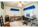 Bright bedroom or office space features neutral carpet, a floral couch and coordinating blue window treatments at 10 Webb Rd, Winter Haven, FL 33881