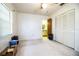 Comfortable bedroom with window views, a ceiling fan, and closet, conveniently located near the bathroom at 10 Webb Rd, Winter Haven, FL 33881