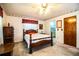 Cozy bedroom showcasing a wooden bed frame and a ceiling fan, offering a peaceful retreat at 10 Webb Rd, Winter Haven, FL 33881