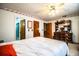 Bright bedroom boasts a wooden bed frame, ensuite bath access, and double door closets at 10 Webb Rd, Winter Haven, FL 33881