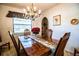 This dining room showcases a wooden table, vintage chandelier, and an archway at 10 Webb Rd, Winter Haven, FL 33881