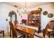 Elegant dining room featuring a wood table, chandelier, and vintage china cabinet exudes classic charm at 10 Webb Rd, Winter Haven, FL 33881