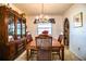 Elegant dining room with wooden table, chairs, chandelier, and built in wood display cabinet at 10 Webb Rd, Winter Haven, FL 33881