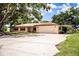 Single story home featuring a spacious driveway and carport, perfect for outdoor entertaining and relaxation at 10 Webb Rd, Winter Haven, FL 33881
