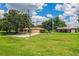 Charming ranch-style home with a large front yard and additional storage building at 10 Webb Rd, Winter Haven, FL 33881