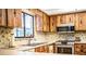 Close up of the kitchen area with stainless appliances and a window overlooking the outdoors at 10 Webb Rd, Winter Haven, FL 33881