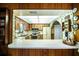 Bright view into the kitchen with stainless appliances, light countertops, and wood-look cabinets at 10 Webb Rd, Winter Haven, FL 33881