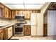 Bright kitchen showcasing stainless steel appliances, light countertops, and wood-look cabinets at 10 Webb Rd, Winter Haven, FL 33881