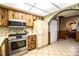 View of the kitchen, featuring stainless appliances, light countertops, and wood-look cabinets at 10 Webb Rd, Winter Haven, FL 33881
