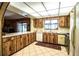 Classic kitchen with wood cabinetry, white appliances, and a bright window over the sink at 10 Webb Rd, Winter Haven, FL 33881