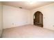 The spacious living room has neutral carpeting, an arched doorway and a light fixture at 10 Webb Rd, Winter Haven, FL 33881