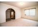 Bright living room with neutral carpeting, and an arched doorway create a harmonious flow at 10 Webb Rd, Winter Haven, FL 33881