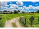 Scenic view of a large, grassy property with a dead end sign and a gated entrance at 10 Webb Rd, Winter Haven, FL 33881