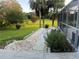 Paver walkway through the lush backyard landscaping and pool area at 1011 Tequesta Trl, Lake Wales, FL 33898
