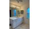 Bathroom vanity featuring a large mirror, white cabinets, and a window at 1011 Tequesta Trl, Lake Wales, FL 33898