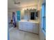 Bathroom showcasing a walk-in shower with a seat, a vanity, and a large mirror at 1011 Tequesta Trl, Lake Wales, FL 33898