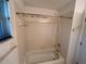 Standard bathtub with decorative shower curtain hooks for added style at 1011 Tequesta Trl, Lake Wales, FL 33898