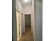 Hallway with two doors, carpeted floor, neutral colors, and great accessibility at 1011 Tequesta Trl, Lake Wales, FL 33898