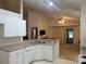 Open kitchen with sleek countertops and ample lighting, flowing into the living and dining areas at 1011 Tequesta Trl, Lake Wales, FL 33898
