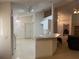 Efficient kitchen featuring white cabinets, sleek countertops, and convenient breakfast bar seating area at 1011 Tequesta Trl, Lake Wales, FL 33898