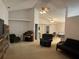 Open-concept living room with vaulted ceilings and neutral tones, perfect for relaxation and entertainment at 1011 Tequesta Trl, Lake Wales, FL 33898