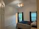 Main bedroom with vaulted ceilings, windows, and natural light at 1011 Tequesta Trl, Lake Wales, FL 33898