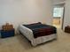 Main bedroom with vaulted ceilings, neutral paint, and an open doorway at 1011 Tequesta Trl, Lake Wales, FL 33898