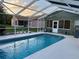 Sparkling pool with a screened enclosure at 1011 Tequesta Trl, Lake Wales, FL 33898