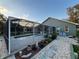 Backyard view of the screened-in pool, landscaping, and exterior of the home at 1011 Tequesta Trl, Lake Wales, FL 33898