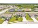 Aerial view of a residential neighborhood featuring homes with solar panels and lush landscaping at 1028 15Th Ne St, Winter Haven, FL 33881