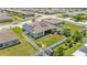 Aerial view of the home's backyard with solar panels, a playground, and fenced perimeter at 1028 15Th Ne St, Winter Haven, FL 33881