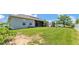 Spacious backyard with green grass, a playground, and a screened patio, perfect for outdoor fun at 1028 15Th Ne St, Winter Haven, FL 33881