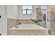 Bathroom featuring a soaking tub and a glass-enclosed shower at 1028 15Th Ne St, Winter Haven, FL 33881