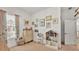 Bright bedroom with a window, neutral carpet, whimsical wall art, and a vanity at 1028 15Th Ne St, Winter Haven, FL 33881