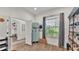 Bright bedroom with wood-look flooring, natural light, and a built-in shelving unit at 1028 15Th Ne St, Winter Haven, FL 33881