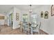 Bright dining area featuring a wooden table with seating for six and natural lighting from windows at 1028 15Th Ne St, Winter Haven, FL 33881